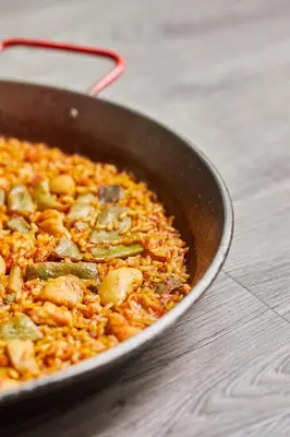 a pan filled with rice and vegetables on a table at Silken Puerta Valencia in Valencia