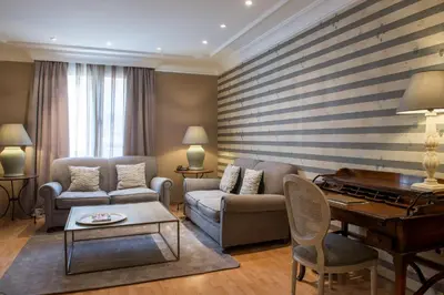 a living room with a couch and a piano at Vincci Lys in Valencia