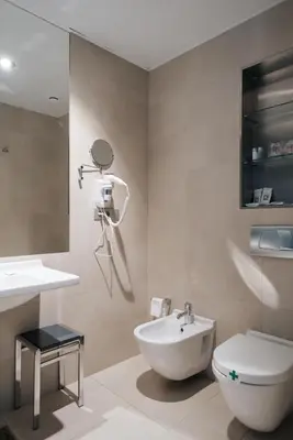 a bathroom with a toilet and a sink at Hotel Neptuno Playa & Spa in Valencia