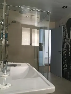 a bathroom with a tub and a glass shower at Hotel Neptuno Playa & Spa in Valencia