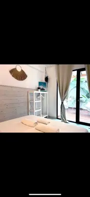 a bedroom with a large bed with a window at New Cozy Beach apartment, WiFi in Valencia