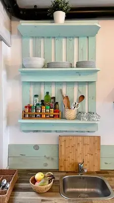 a kitchen with a sink and a shelf with dishes at New Cozy Beach apartment, WiFi in Valencia