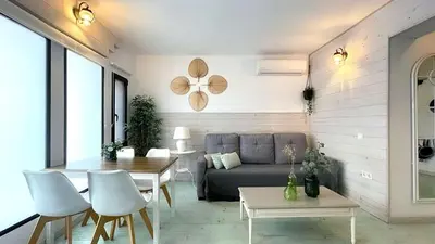 a living room with a couch and a table at New Cozy Beach apartment, WiFi in Valencia