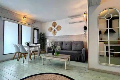 a living room with a couch and a table at New Cozy Beach apartment, WiFi in Valencia