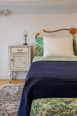a bedroom with a bed with a pillow and a nightstand at Artistic Loft, Full Of Light - City Center Ruzafa in Valencia