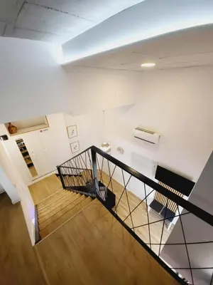 a staircase in a building with white walls and wooden floors at Carbonell 1 in Valencia