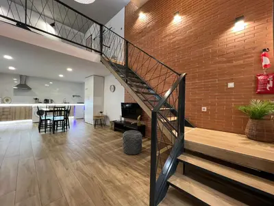 a staircase in a living room with a brick wall at Carbonell 1 in Valencia