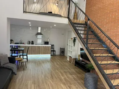a staircase leading to a living room and a kitchen at Carbonell 1 in Valencia
