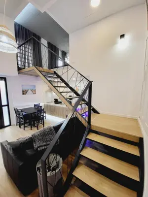 a spiral staircase in a living room with a table at Carbonell 1 in Valencia
