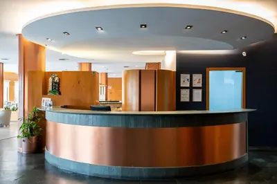 a lobby with a circular counter in a building at Posadas De España Paterna in Paterna