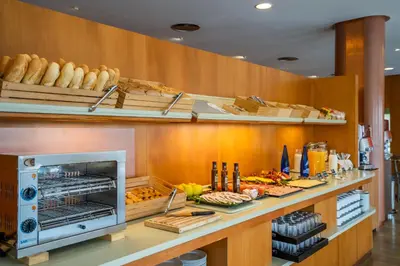 a buffet line with bread and pastries in a restaurant at Posadas De España Paterna in Paterna