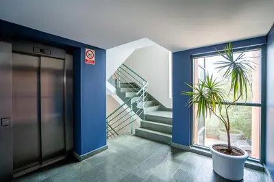 a hallway with a staircase and a potted plant at Posadas De España Paterna in Paterna