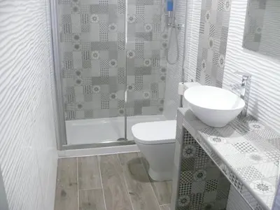 a bathroom with a shower and a toilet and a sink at HOSTAL LETTO DAL MARE in Valencia