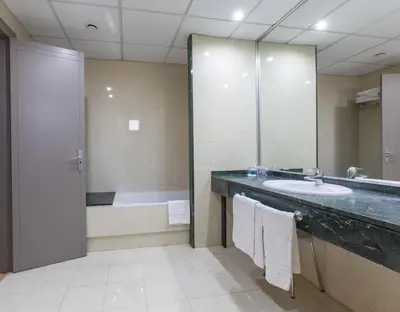 a bathroom with a sink and a shower and a tub at Hotel Olympia Valencia in Alboraya
