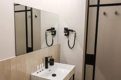 a bathroom with a sink and a mirror at Mythic Valencia in Valencia