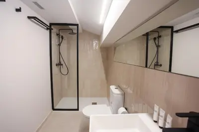 a bathroom with a shower and a toilet and a sink at Mythic Valencia in Valencia
