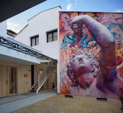 a mural on the side of a building at Mythic Valencia in Valencia