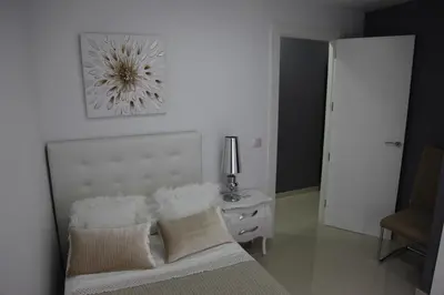 a bedroom with a bed and a table with a lamp at Apartamentos Alogia, Pastora, Yerbater in Segorbe