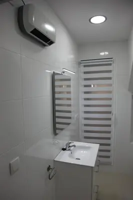 a white bathroom with a sink and a mirror at Apartamentos Alogia, Pastora, Yerbater in Segorbe