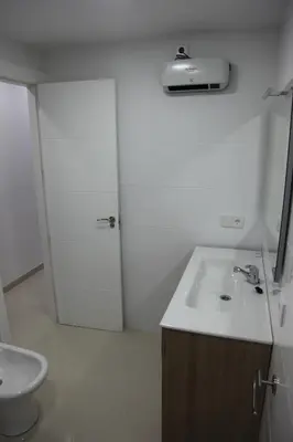 a white bathroom with a sink and a toilet at Apartamentos Alogia, Pastora, Yerbater in Segorbe