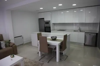 a kitchen with a table and chairs in a room at Apartamentos Alogia, Pastora, Yerbater in Segorbe