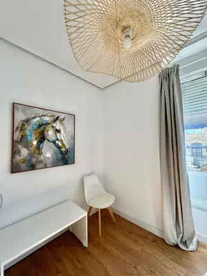a living room with a painting of a horse on the wall at Vlc Center 4 Room Apartment in Valencia