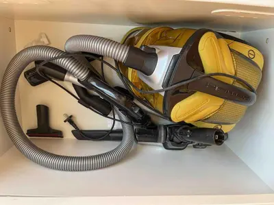 a yellow suitcase and a hose hanging from a wall at Vlc Center 4 Room Apartment in Valencia