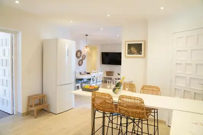 a kitchen and dining room with a white refrigerator at El Oasis Villa Resort in La Eliana