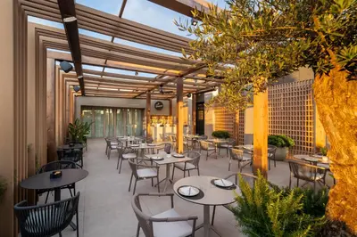 a restaurant with tables and chairs and a tree at SH Valencia Palace in Valencia