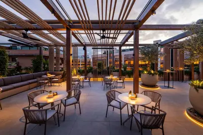 a patio with tables and chairs and a couch at SH Valencia Palace in Valencia