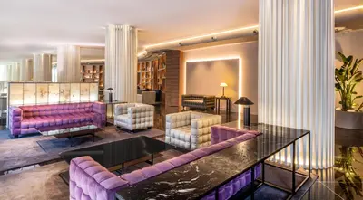 a living room with purple couches and a table at SH Valencia Palace in Valencia