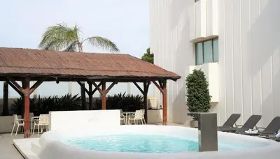 a swimming pool with a gazebo and chairs at Port Azafata Valencia in Manises