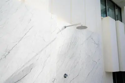 a white marble shower with a shower head at Port Azafata Valencia in Manises