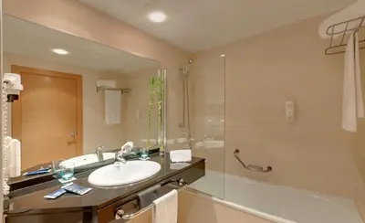 a bathroom with a sink and a shower at Ramada by Wyndham Valencia Almussafes in Almussafes