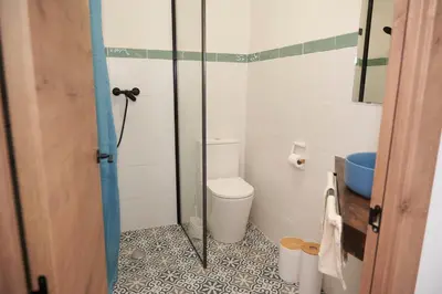 a bathroom with a toilet and a glass shower at El mas allà in Chulilla