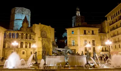 a fountain in front of a building at night at Hotel Albufera in Alfafar