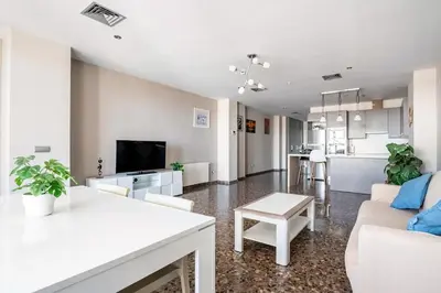 a living room with a couch and a table at Moderno apartamento con vistas al mar en Valencia in Valencia