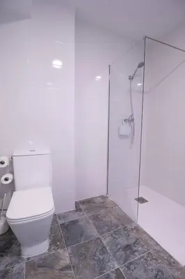 a bathroom with a toilet and a glass shower at Viveros by Concept Flats in Valencia