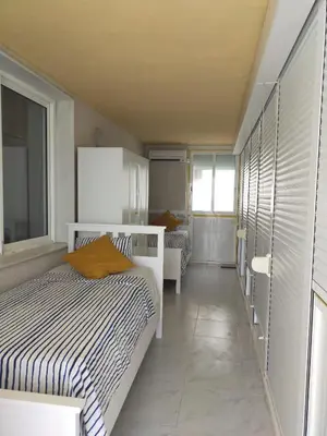 a bedroom with two beds and a window at Florazar 3 in Cullera