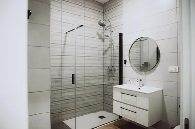 a bathroom with a shower and a sink and a mirror at APARTAMENTOS LEO XIII in Valencia