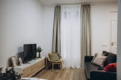 a living room with a couch and a tv at APARTAMENTOS LEO XIII in Valencia