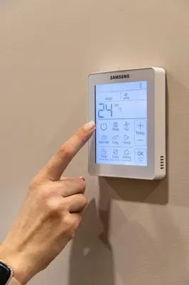 a person pointing to a thermometer on a wall at Art Lofts Gardens in Valencia