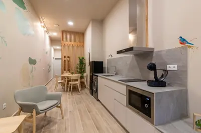 a kitchen with a counter and a table and chairs at Art Lofts Gardens in Valencia