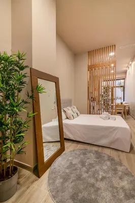 a bedroom with a large mirror and a bed at Art Lofts Gardens in Valencia
