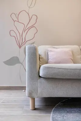 a couch in a living room with a pink pillow at Art Lofts Gardens in Valencia