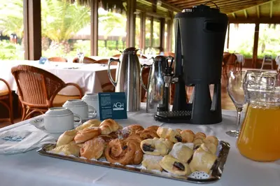 a table with a tray of pastries and a coffee maker at AGH Canet in Canet de Berenguer