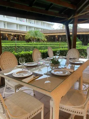 a table with chairs and plates and wine glasses at AGH Canet in Canet de Berenguer