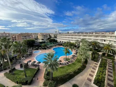 an aerial view of a resort with a pool and palm trees at AGH Canet in Canet de Berenguer