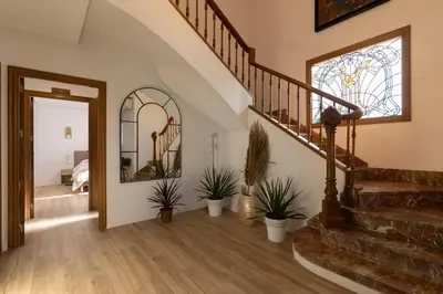 a hallway with stairs and a stained glass window at Villa Huerta 1 Manises, jacuzzi, sauna, piscina in Manises