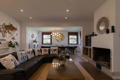 a living room with a black couch and a fireplace at Villa Huerta 1 Manises, jacuzzi, sauna, piscina in Manises